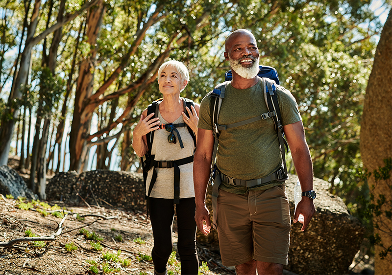 senior interracial couple hiking in woods